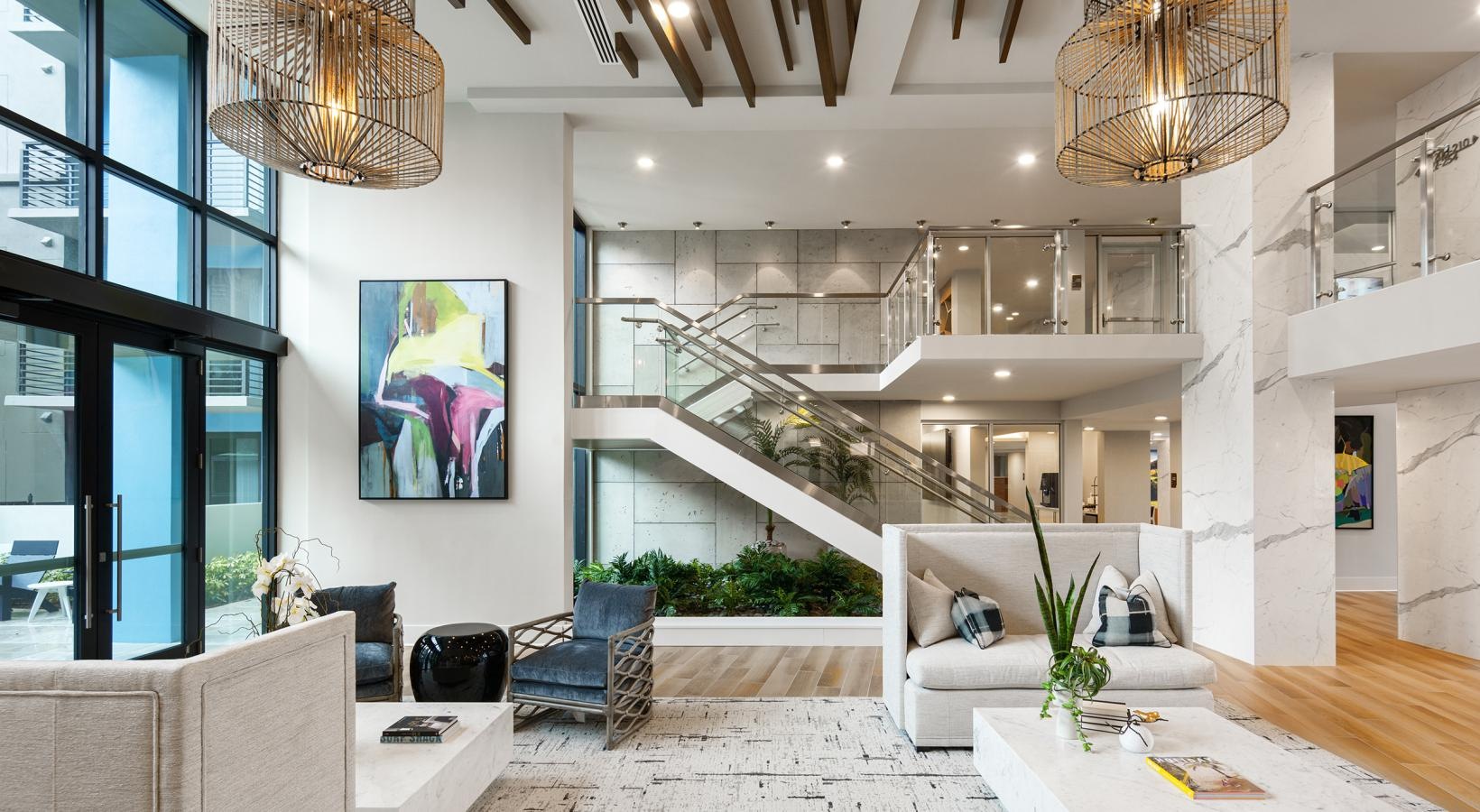 Settle into comfort at CERU a room with a staircase and chandelier