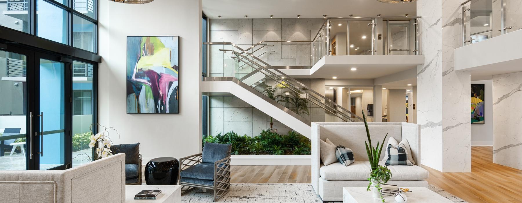 a room with a staircase and chandelier